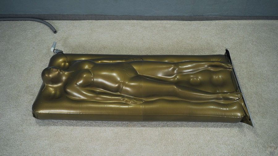Sonya in a gold vacuum bed on a vibro mattress