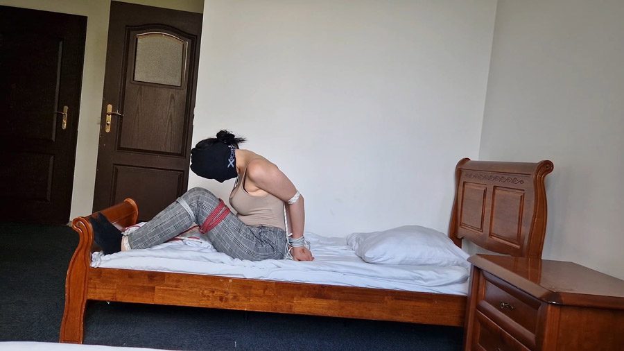 Mily hogtied on bed